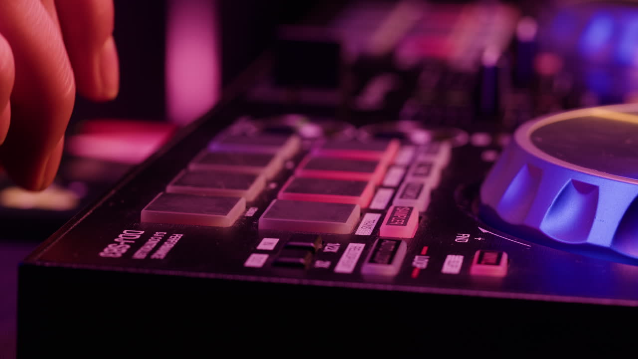 DJ with headphones and sunglasses playing music on festival in night club. Techno musician performing at nightclub for concert crowd of people, city bar.