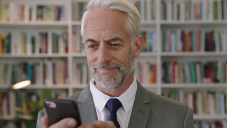 Retrato-De-Un-Hombre-De-Negocios-Profesional-Usando-Un-Teléfono-Inteligente-En-La-Oficina-De-La-Biblioteca-Un-Caballero-Sonriente-Arquitecto-Profesor-Conferenciante