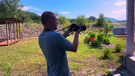 Capturing Moments: A Passionate Photographer Immersed in Nature, Framing the Beauty of the Outdoors with a Professional Camera Against a Scenic Backdrop