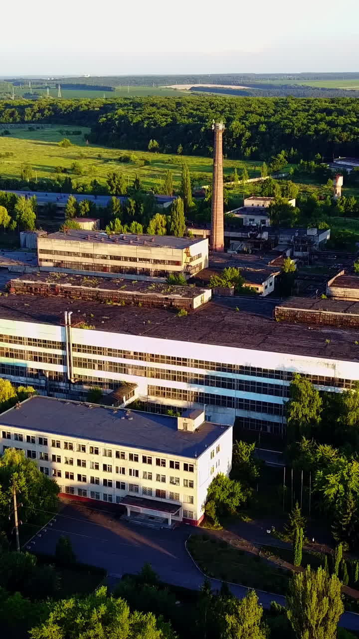 Old Abandoned Factory Buildings. Abandoned old factory buildings with closed door and windows Vertical video