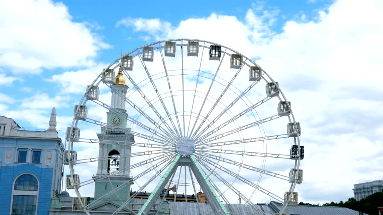 Close-up big white ferris wheel rotates in Kiev city,