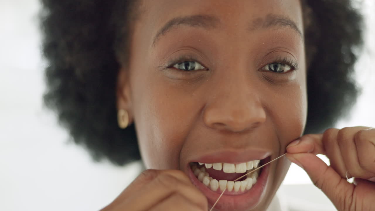 Black woman afro, flossing teeth