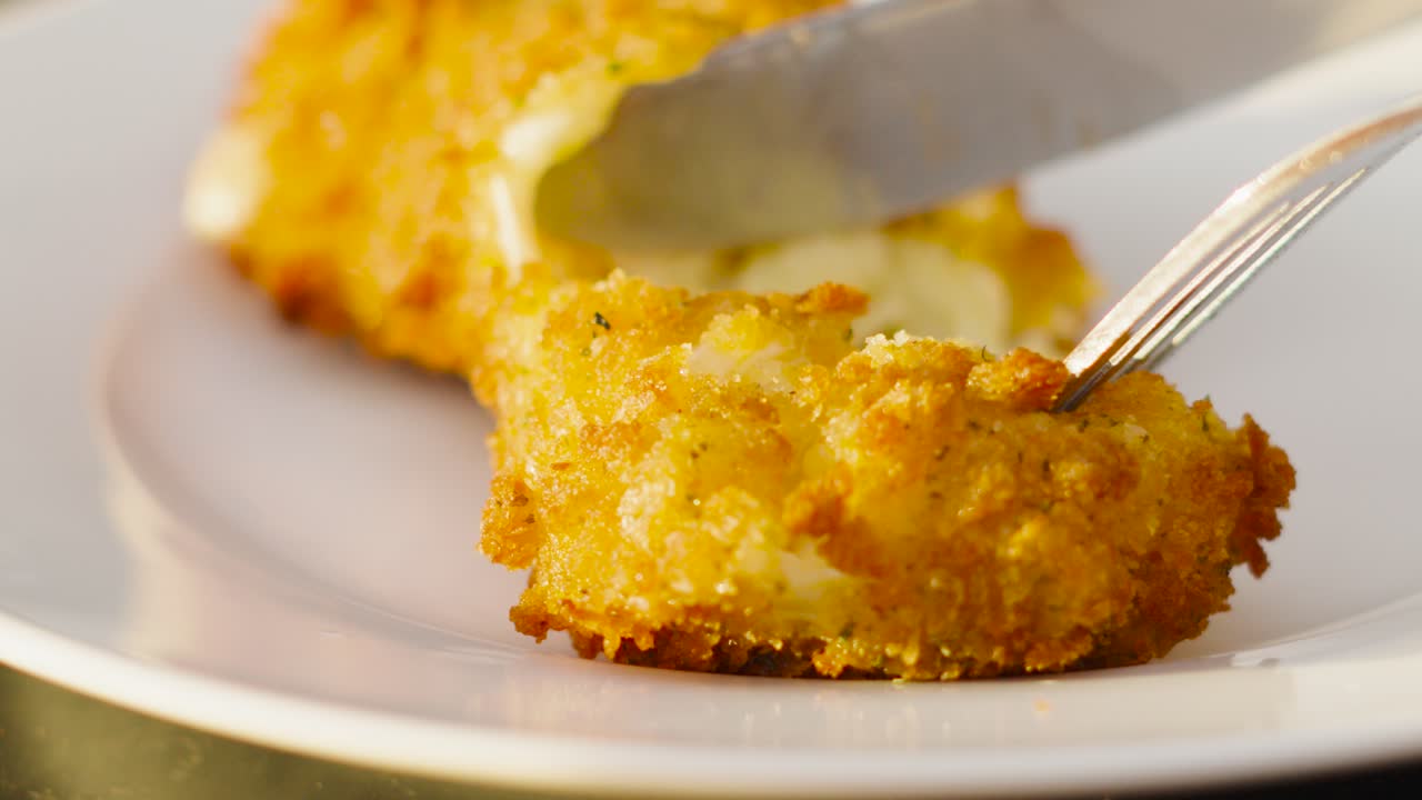 Knife Slowly Cutting into Mac and Cheese Pasta Croquette and Pulling It Apart to Reveal Gooey Cheesey Interior. Slow Motion High Quality Food Clip