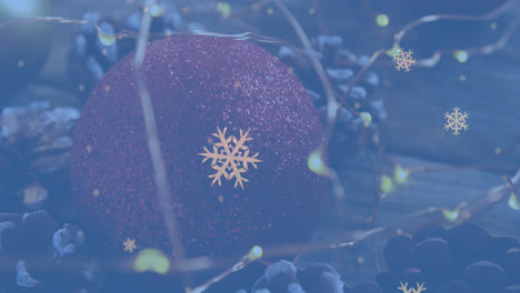 animation of white snowflakes falling over christmas decorations, lights and pine cones