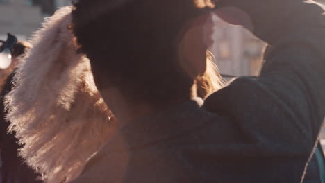 happy young multiracial couple dancing on rooftop at sunset celebrating relationship having fun enjoying playful dance party together