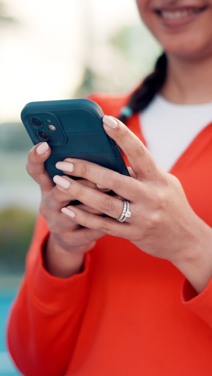Close-up of Person's Hands Scrolling and Using a Smartphone Outdoors