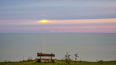 a time lapse shot of a person sitting at the beach at the beach the sunset