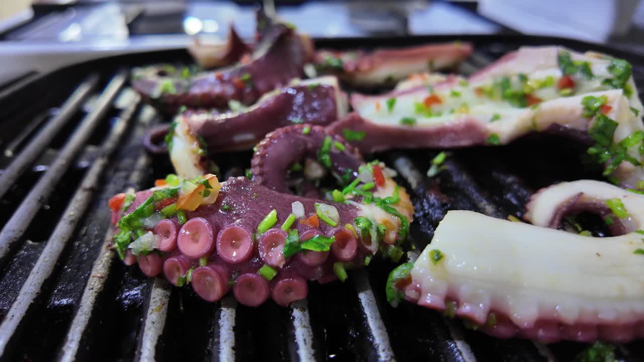 Grilled octopus tentacles sizzling with spices. Fresh, flavorful cooking