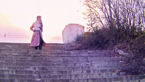 woman walking down stairs at sunset