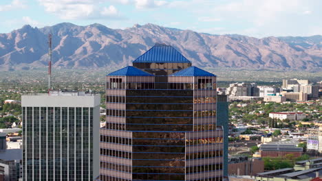 Aerial-view-of-a-building-in-downtown-Tucson,-AZ-with-the-mountains-in-the-background