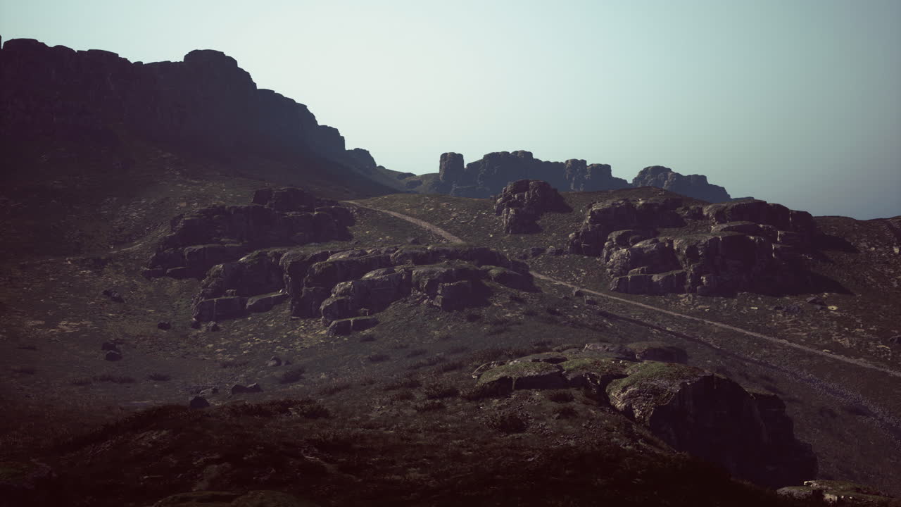 Rocky mountain landscape with winding path amidst rugged terrain