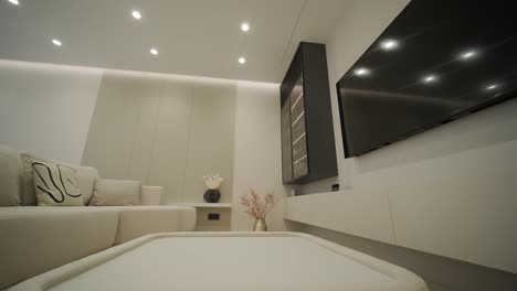 modern living room interior design and decoration with white sofa in living area, dining table and wooden chairs, kitchen counter and cabinets. 4k video 3d rendering apartment room with balcony