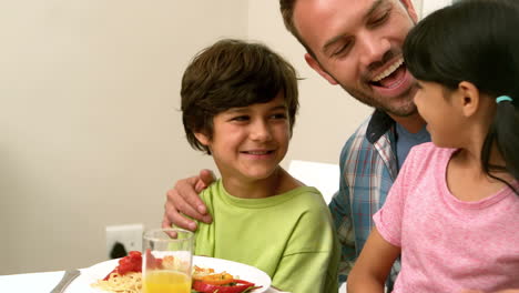 Happy-father-and-kids-having-lunch