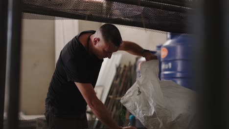 man working with harvested produce in a drying facility