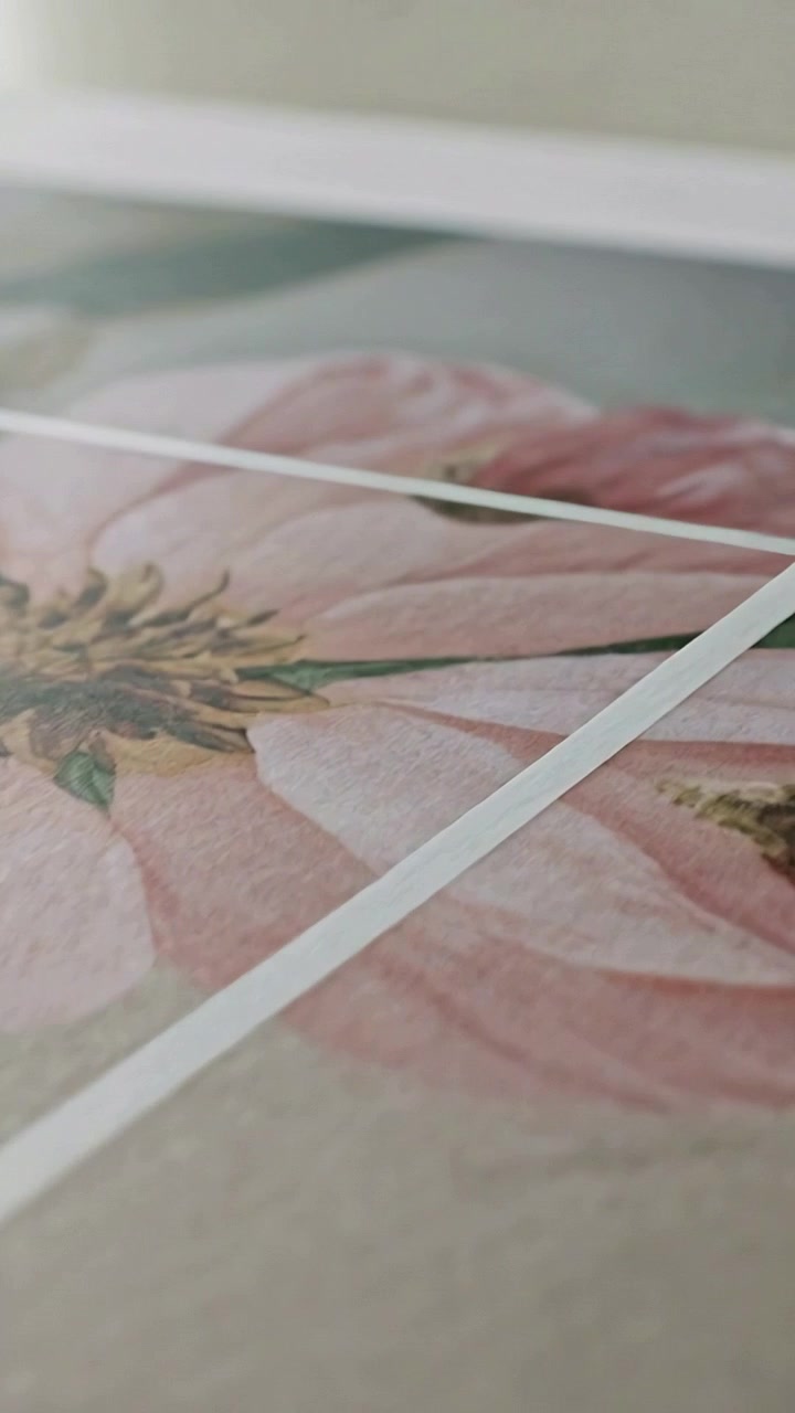 Vertical video: Strip appearing, cam panning on desk showing pink flower on paper, two white strips