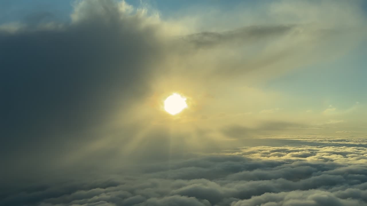 A breathtaking view of ethereal stracocumulus cloud formationas as the sun begins to break through. An aerial footage taken from an airplane cockpit through the pilot’s eyes.