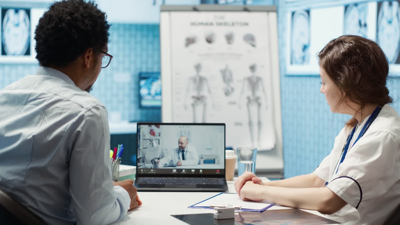 Physician entering a video call with specialist to discuss diagnostic report