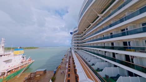 drone flying close around a luxury cruise ship anchored at taino bay cruise terminal in puerto plata, dominican republic