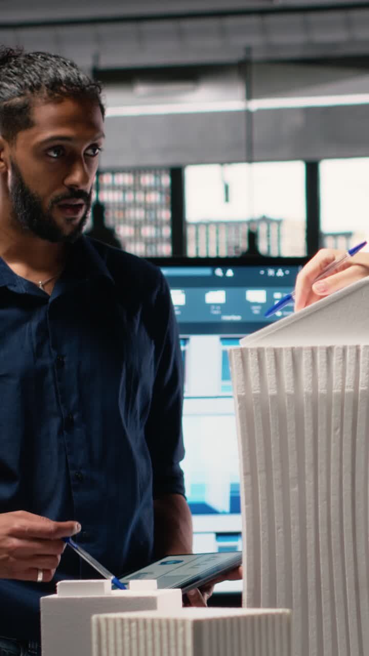 Vertical Video Diverse team of developers sharing construction details in a briefing session