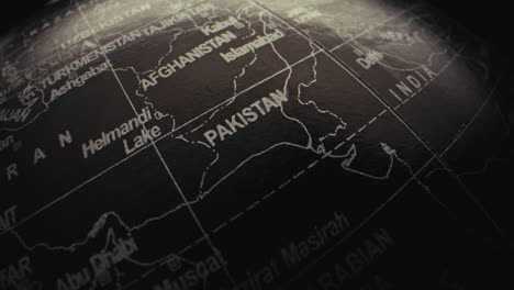 close-up view of a world globe focusing on the asian region, highlighting pakistan and afghanistan.