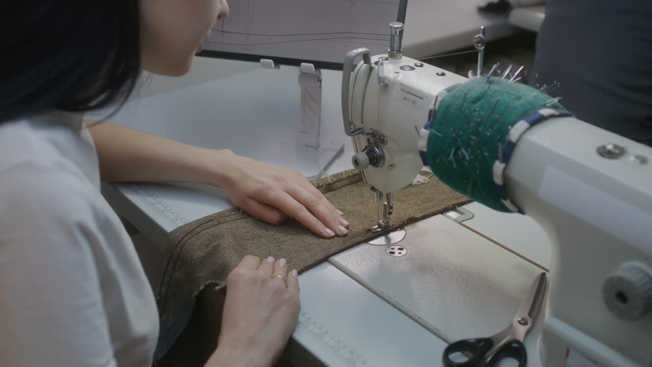 Woman Sewing on a Sewing Machine