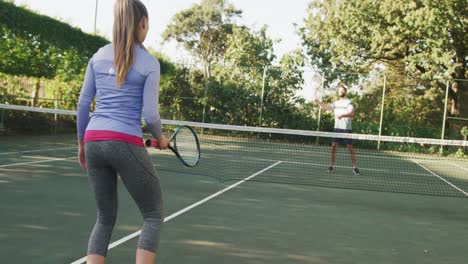 video of happy caucasian woman playing tennis on the court