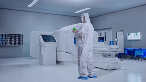 full body back view of asian male scientist use mock up green screen smartphone while standing with mri machine in the hospital