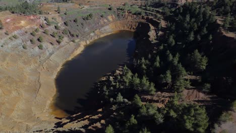 Wide-aerial-view-of-Red-Lake,-also-known-as-Blood-lake-at-the-Mitsero-mines-in-Cyprus,-Greece