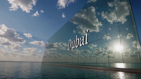 large glass wall featuring the word dubai reflecting a cloudy sky and sunlight over a calm sea surface, creating a stunning urban landscape that embodies modern luxury and prosperity