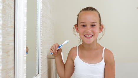 little girl brushing her teeth