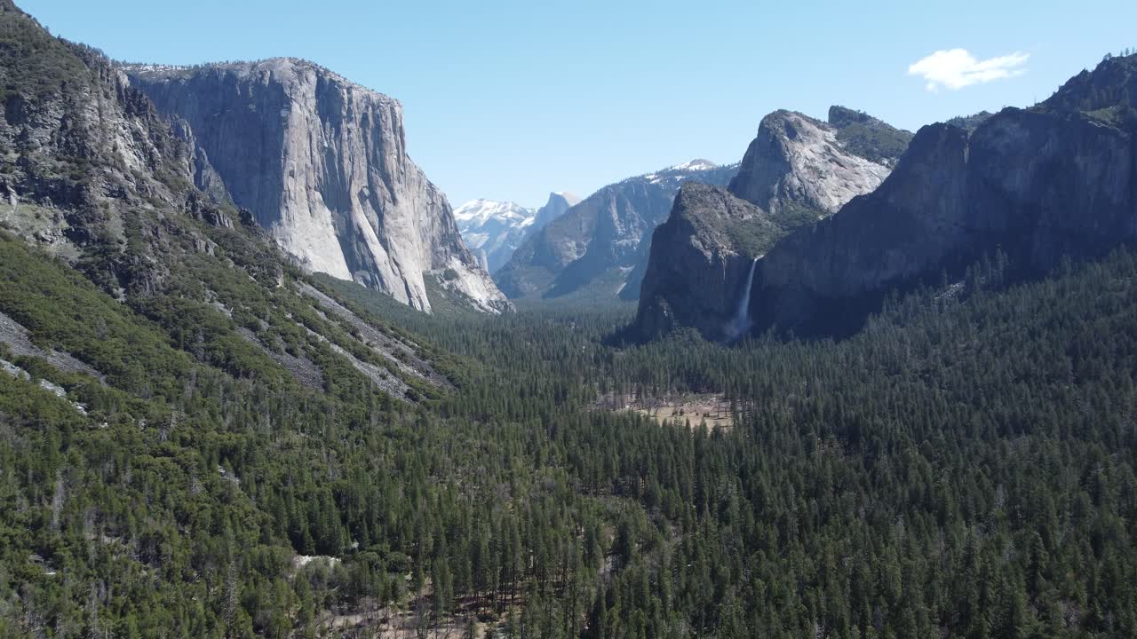 Beautiful Mountain Grandeur Postcard Scenery Of Yosemite National Park, USA. Slow Aerial Approach Towards Bridal Veil Falls From The Famous Tunnel View Overlook.