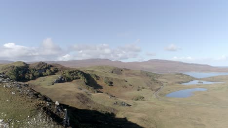 Aerial-tracking-nearby-over-craggy-terrain-to-reveal-the-tiny-loch-cragaidh-and-the-much-larger-Loch-Eriboll-in-the-far-distance