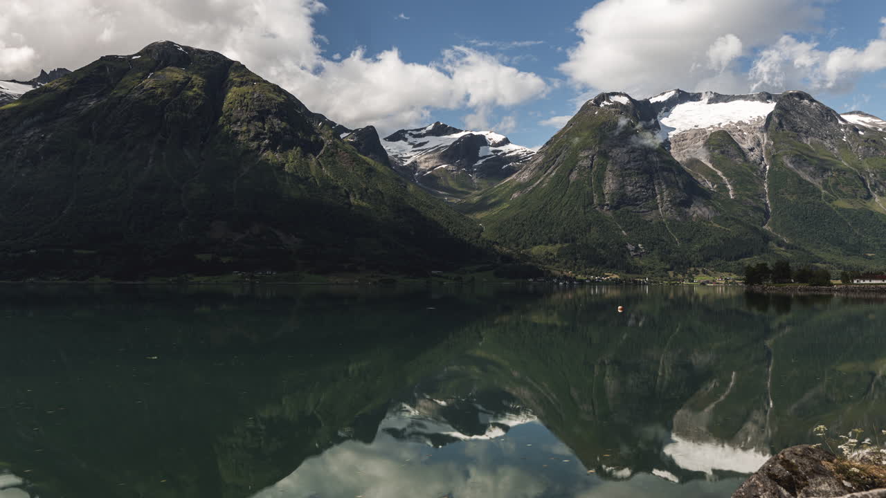 Reflection Of The Lovatnet Lake In Loen, Norway During Daytime - wide shot