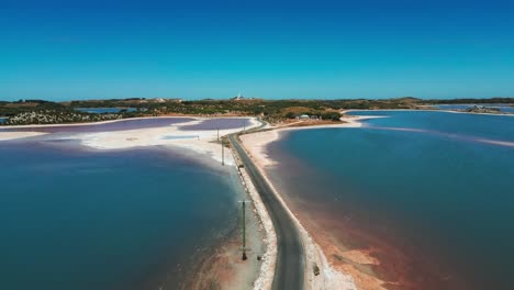 drone-shot-above-digby-drive-on-Rotness-Island-between-two-salty-lakes-with-pink-colors-on-a-summer-day,-western-australia