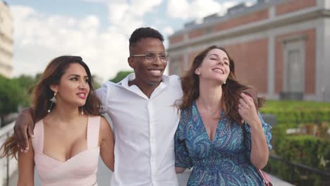 diverse group of happy friends walking together outdoors