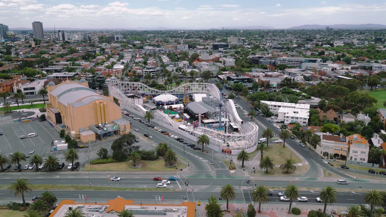 Moving Drone footage of an approach away from Luna Park, an amusement park at St Kilda Beach.