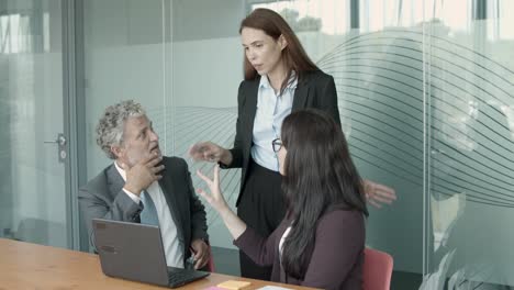 Content-serious-businesspeople-gesturing-and-discussing-project