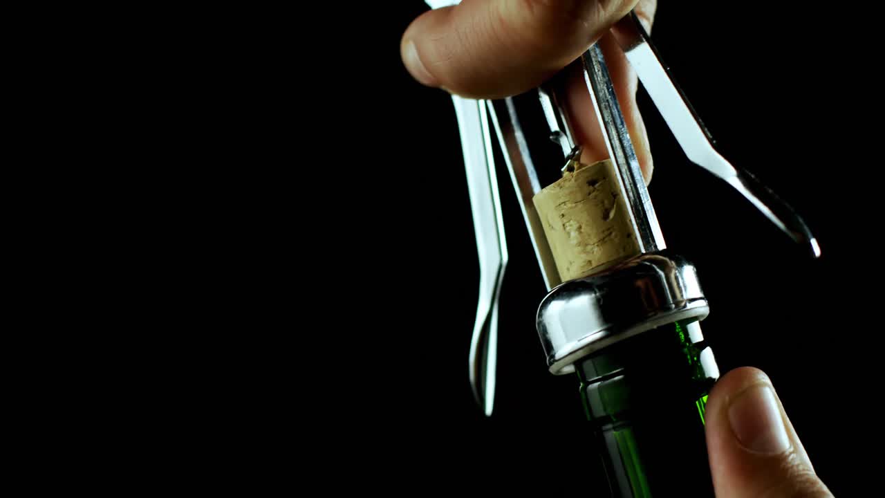Close-up of hand opening the wine bottle 4k