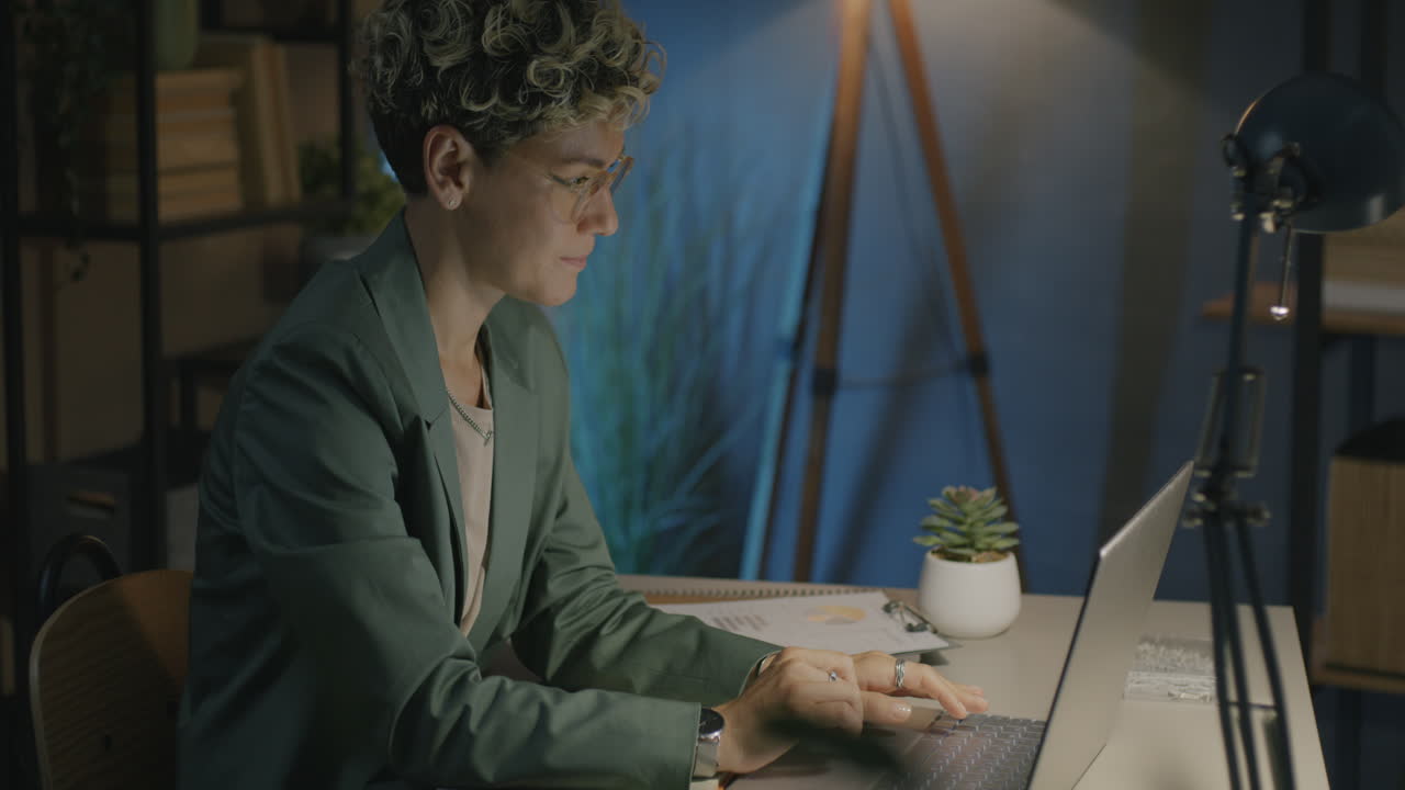 Woman Working Late at Night on Laptop