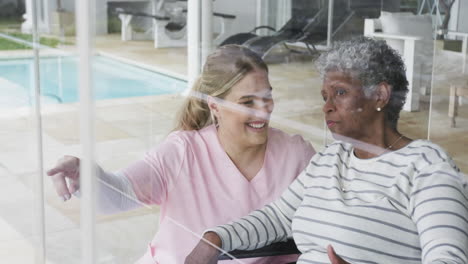 Smiling-caucasian-nurse-with-senior-woman-patient-with-copy-space,-slow-motion