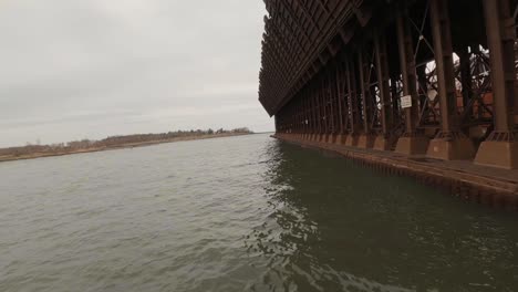 FPC-drone-flying-past-industrial-dock-for-loading-mining-resources-into-freight-ships-on-Lake-Superior