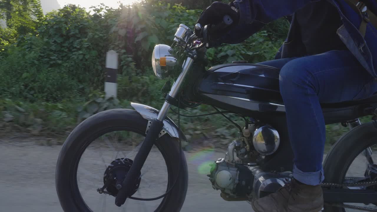 Man Riding a Motorcycle on a Country Road