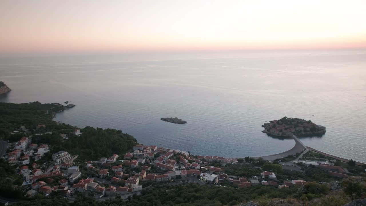 Sunset overlooking the coastline in Montenegro near Sveti Stefan. Camera panning from left to right showing the whole coastline at sunset
