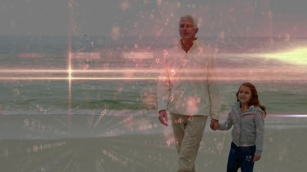 Camera pulling in, senior man and child girl are walking on wet sand with waves, bonding