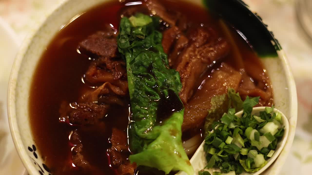 Delicious noodle dish with meat and greens
