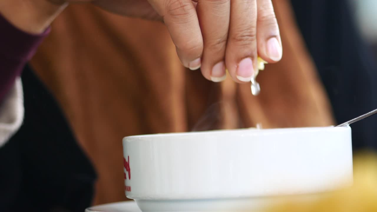 Squeezing Fresh Lemon Juice into a Bowl