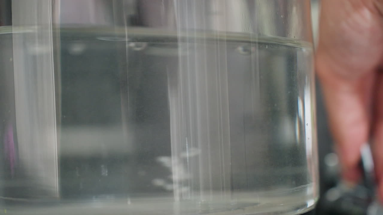 Warm Water Bubbles Rise Subtly, Glass Kettle Reveals Gentle Rising Tiny Bubbles With Soothing Lighting, Capturing Close View Of Inside Kettle With Delicate Bubbles Lifting As Water Heats Up