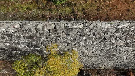 hand built stone wall along decomissioned railway bergensbanen, stanghelle norway