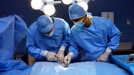 surgeons performing operation in operation room