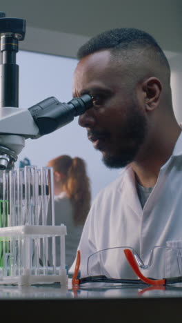 scientist using microscope in lab